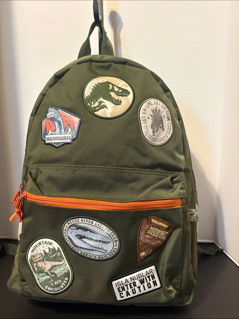 Universal Jurassic Olive Green Dinosaur Patch Backpack with Bright Orange Zipper